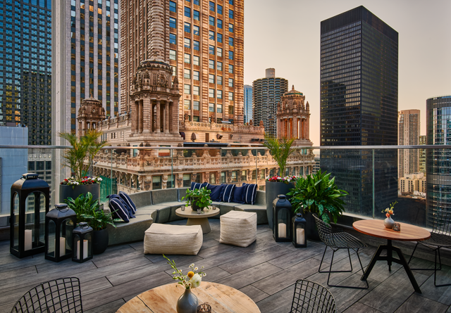 Cerise rooftop patio at Virgin Hotels Chicago with stylish seating, vibrant decor, and panoramic city views.