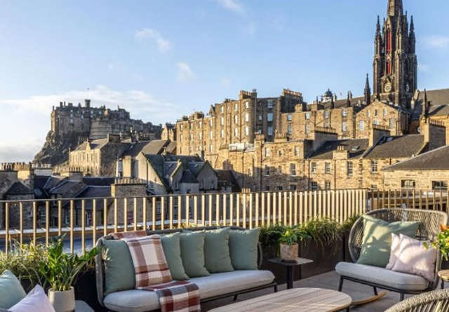 Virgin Hotels Edinburgh rooftop seating area overlooking the castle.